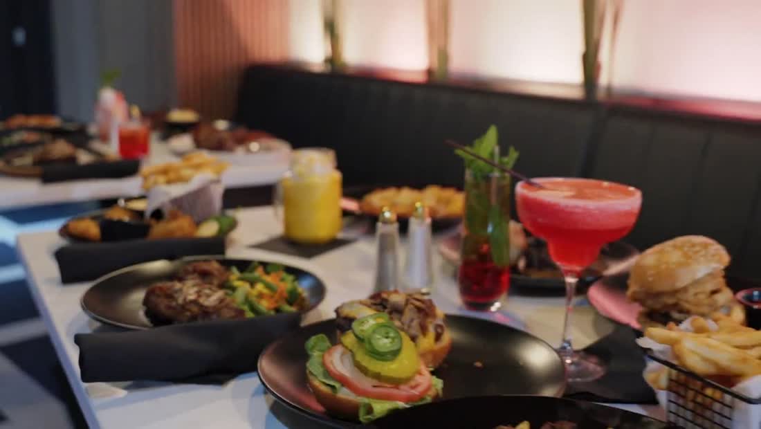 A table spread of steaks, fajitas, and drinks at Affy's