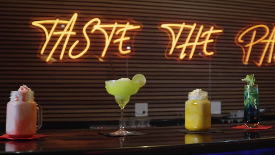 A row of colorful mocktails on the bar